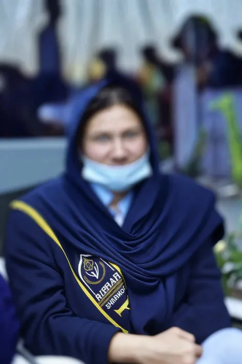 Create a photorealistic image of Dr.Fida (include name tag Dr.Fida) wearing a peach chikankari and a shawl around her head winning a medal in psychiatry quiz with a background of a stage on which people are sitting and its written SIPSCON 2024 in the background