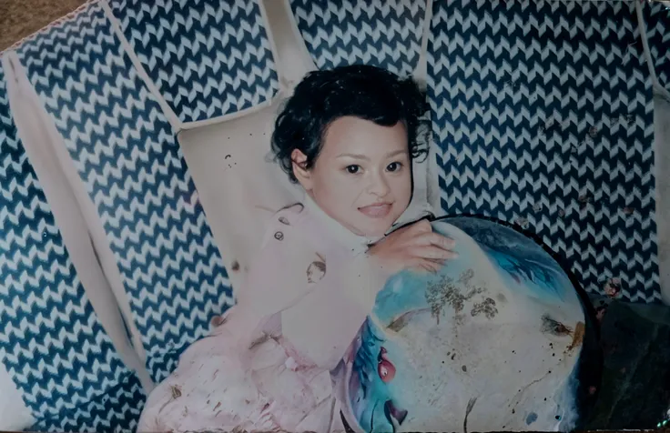 There is a baby sitting on the sofa holding a toy, coloured photo, about 3 5 years old, Sitting on the sofa, he is about 2 5 years old, she is about 2 5 years old, old picture, he is about 30 years old, he is about 3 0 years old, childhood friend, He is! about 3 0 years old