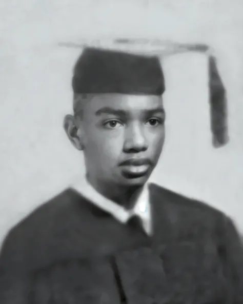 African American boy in a black mantle of a school graduate