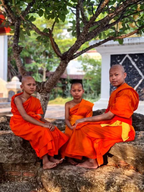 2 tall and handsome young Khmer monk smile and alot young woman look at them in 1800s