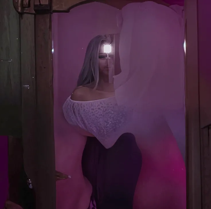 1 girl, fair_skin, ((white long hair)), large ass, ((wearing pink short dress)), full lips, pretty long eyelashes, pretty eyebrows, soft looking skin, realistic bedroom, masterpiece, wearing diamond earrings, sitting on bed, looking at viewer, ((blue eyes))