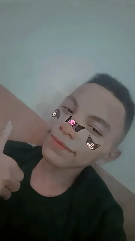 there is a young man making a peace sign with his fingers, black teenager, perfect face and child, about 1 9 years old, holding it to the camera, low quality photography, very very low quality image, looking directly at the camera, perfectly lit face, holding his hands to his face, looking directly at the camera, 18 years old,  Melanie Martinez style, best quality, masterpiece, high resolution, tyndall effect, photorealistic, dark studio, edge lighting, two-tone lighting (skin with high level of detail: 1.2), 8k uhd, dslr, soft lighting, high quality, volumetric lighting, sincere, photography, high resolution, 4k, 8k, Bokeh
