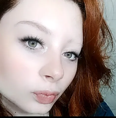 Kruzadar woman wearing a cheerleading uniform, dark red hair, blue eyes, long hair, hyper realistic, 4k, masterpiece, beautiful, facing the viewer, headshot, ((white skin)), cleavage,cumfacial55