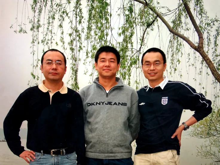 three men standing in front of a building with a large glass structure, in hong kong, from china, wu liu, with shiny glass buildings, zezhou chen, scanned in, ruan jia and fenghua zhong, with many travelers, zhuoxin ye, steve zheng, kan liu, wei wang, qi sheng luo, ruan jian