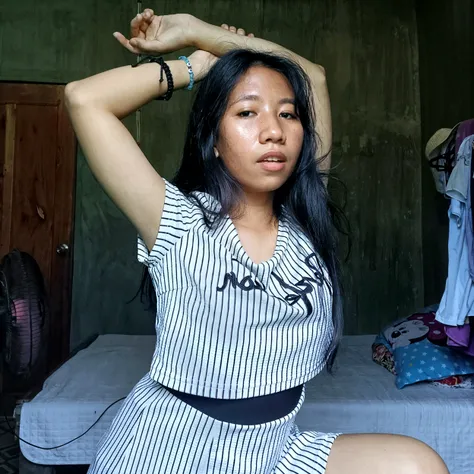 Filipino woman has acute scabies all over her body. White and thin skin. tattooed. wearing a singlet and side slit mini skirt.