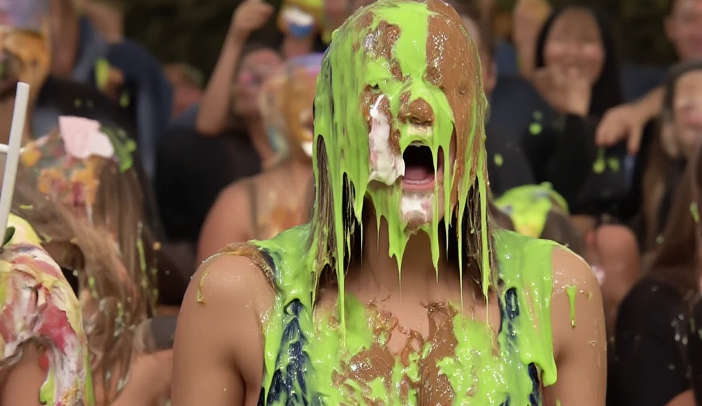 On a TV gameshow, a beautiful young 18-year-old woman with very long straight blonde hair and wearing a dark blue velvet dress is completely covered from head to toe in pies, green gunge, blue gunge, melted chocolate and melted strawberry ice cream.  Full body shot.