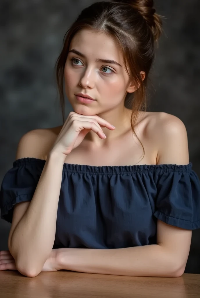 A young woman with blue eyes and dark brown hair in a loose updo, wearing an off-the-shoulder dark blue top, sitting at a table, leaning forward, with one hand touching her chin, soft contemplative expression, dark blurred background