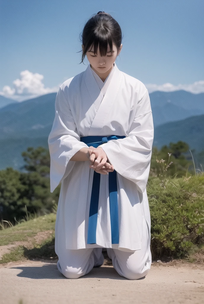 A kneeling samurai praying in white and blue clothes against a background of clear blue sky 