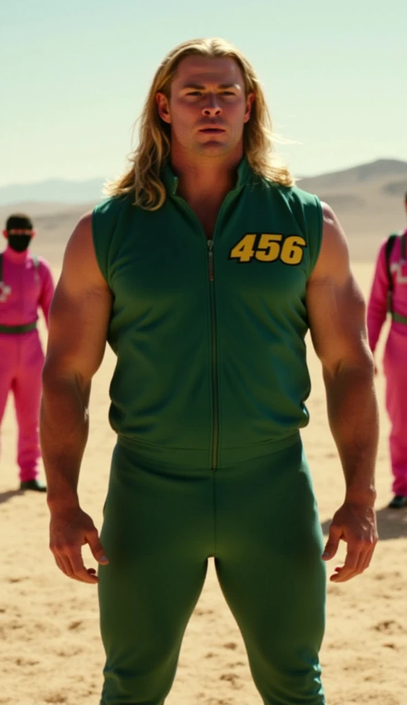 Thor, dressed in a green tracksuit with the number '456' on the chest and back, standing in the Squid Game arena. His muscular build is evident, and his long, flowing blonde hair adds to his powerful appearance. The tracksuit fits him perfectly, emphasizing his heroic presence. The background is a vast, sandy field with ominous guards in pink jumpsuits and black masks. The lighting is dramatic, casting long shadows that add to the suspenseful atmosphere. Thor's expression is focused and determined, ready to face the high-stakes game with strength and courage.