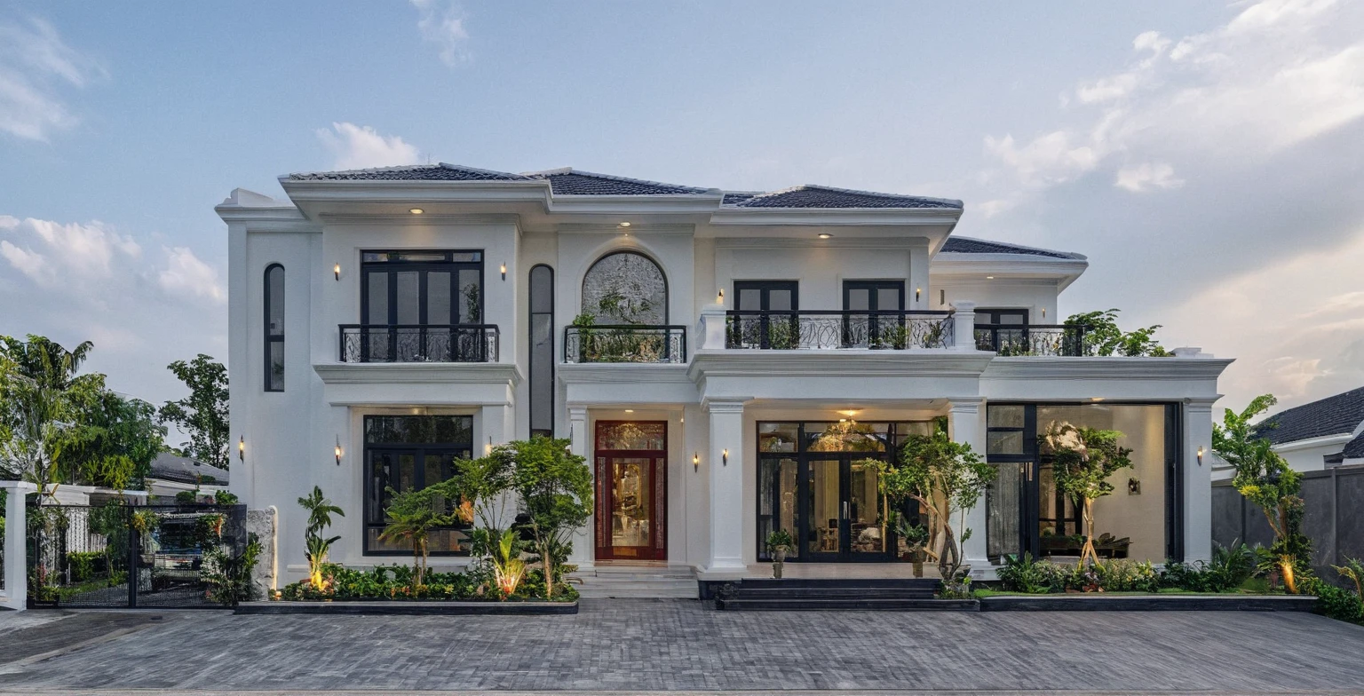 (masterpiece:1.2), best quality, photo of A two-story modern house in VietNam with white walls and dark tiles on the roof., tree and plant environment,daylight, streetcapes, natural light, vivid color, The exterior of an elegant single family home features large windows, a dark gray door frame.