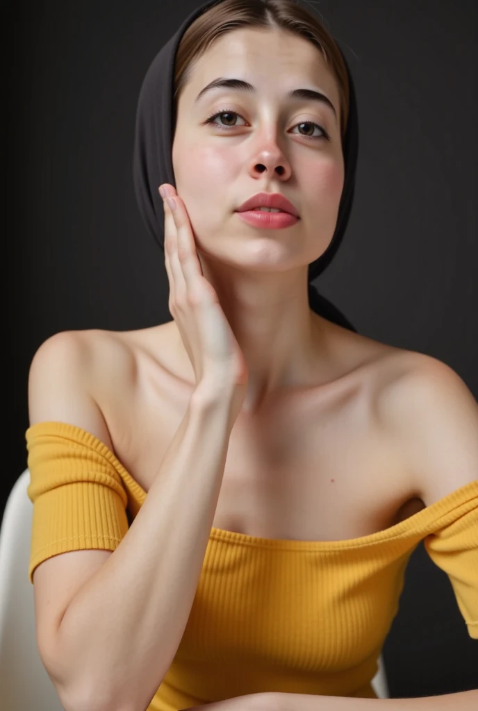 A young woman with blue eyes and dark brown hair in a loose updo, wearing an off-the-shoulder yellow top, sitting at a table, leaning forward, with one hand touching her chin, soft contemplative expression, dark blurred background
