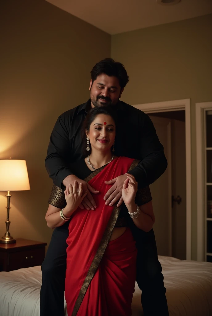 Beautiful and Slim Indian woman Aishwarya Rai in black blouse red saree , lifting a large chubby man above her shoulders, man is sitting on woman's shoulders, natural smile, in a bedroom with high ceiling at night