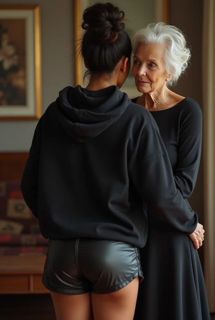 black woman hair in a bun black hoodie shiny black leather short shorts pockets in shock as a old grandma in a dress on her knees kissing her ass behind her hand is in her ass holding her ass backside view