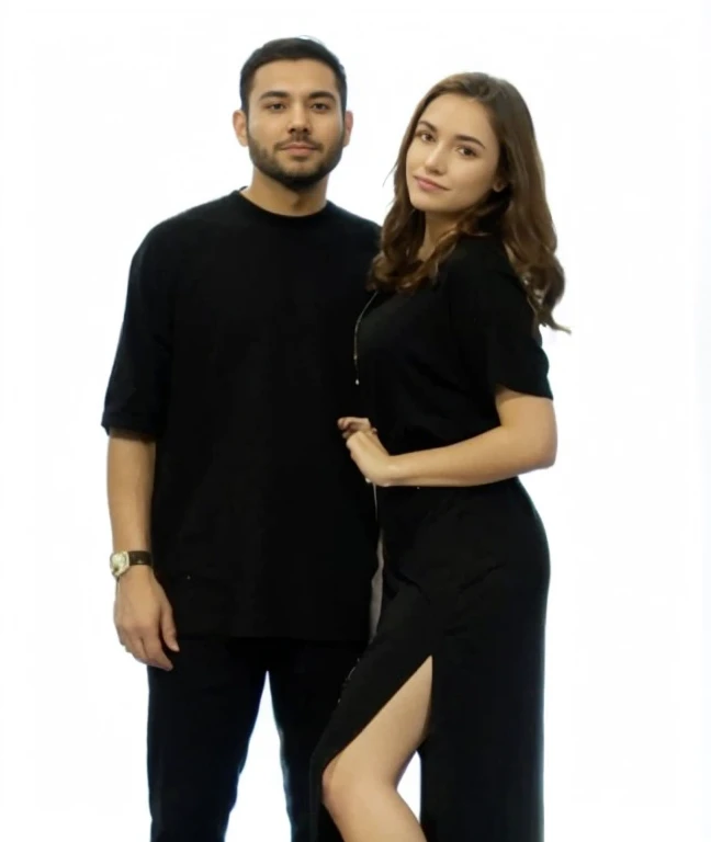 The man's shirt is light-black, his pants are black, and he has a watch on his left hand. The woman is wearing a light-purple dress, her hair is black, and she is wearing a watch on her right hand. Both are a couple. The color of the skin is pale. The floor is an old house indian cupple