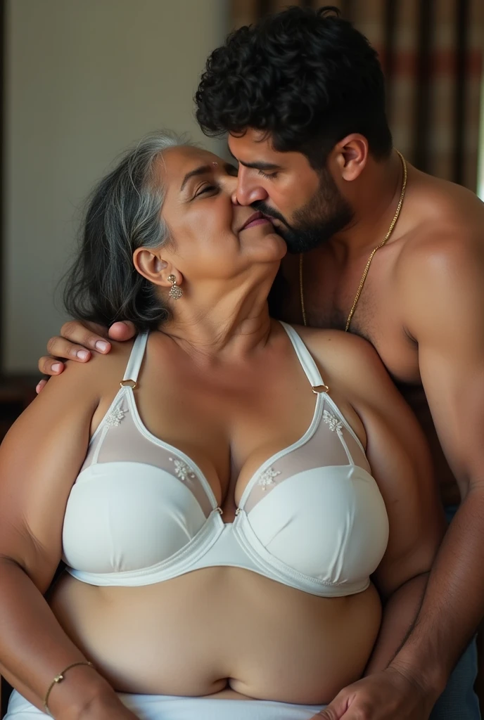 A beautiful gorgeous plump Indian 60 woman wearing a bra panty, long hair, huge breasts, hot body curves, smiley face, white skin, laying on bed with 25 years handsome man