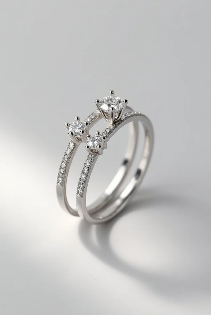 A two silver ring resting on each other with Diamond on it