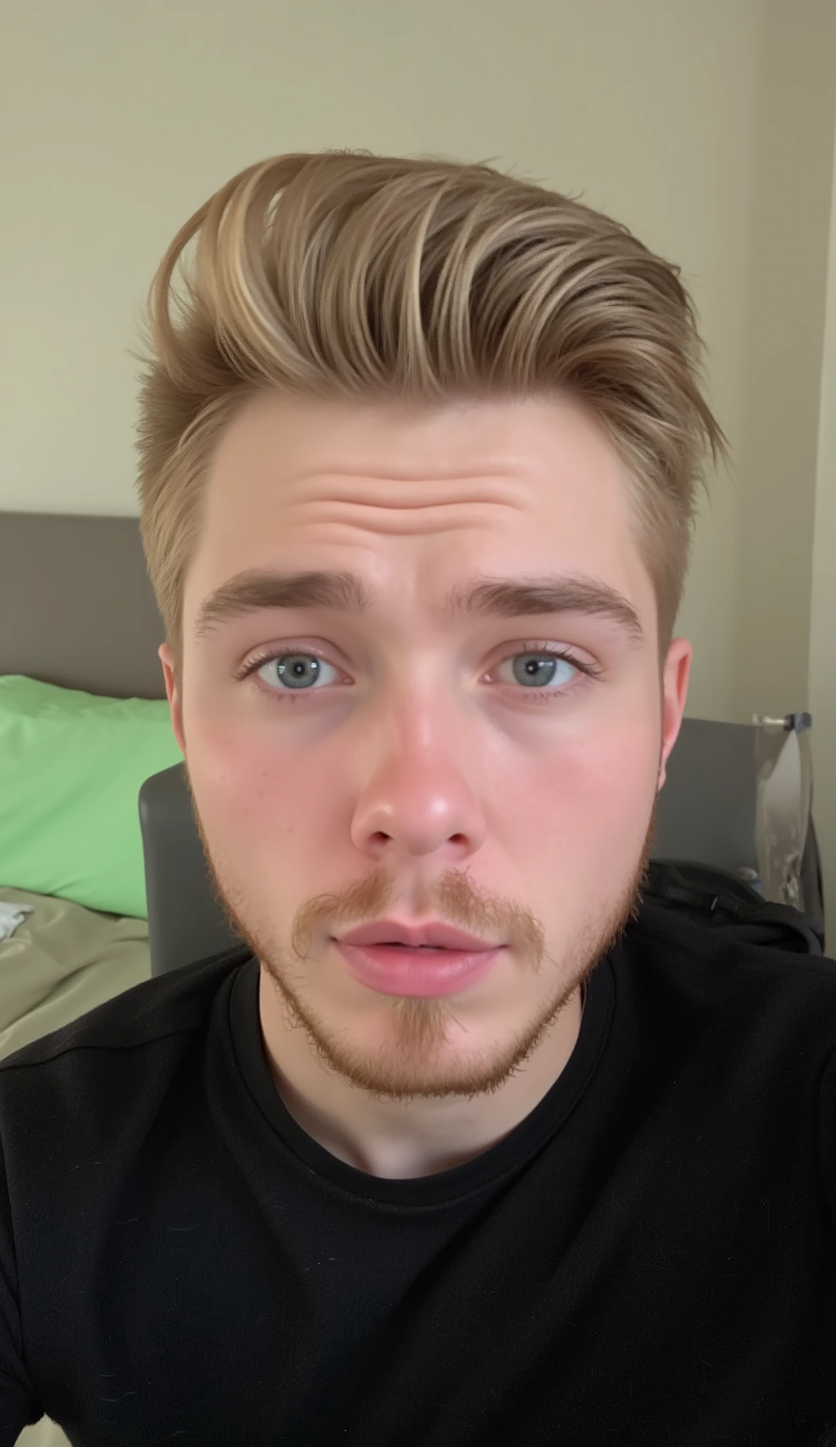 A young man with fair skin , well trimmed short beard and short hair combed and blond , looking directly at the camera with an expression that causes curiosity in those who see. Your clear and well-defined blue eyes. He is wearing a simple black shirt . The background of the image is there a PC game and a chair , with soft lighting creating a light effect around . The setting includes a bed with greenish sheets in the background, suggesting a bedroom environment . THE IMAGE MUST BE OF HIGH QUALITY, with detailed realism and good lighting. It needs to be facing the image