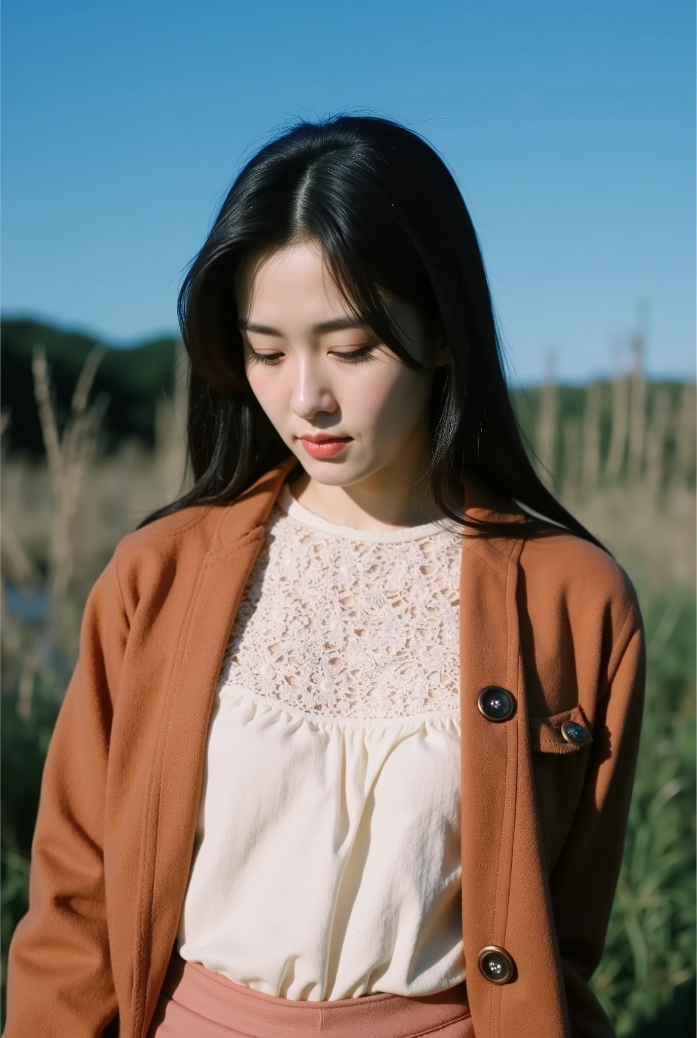 Arafed woman in a brown jacket and pink pants standing in a field ...
