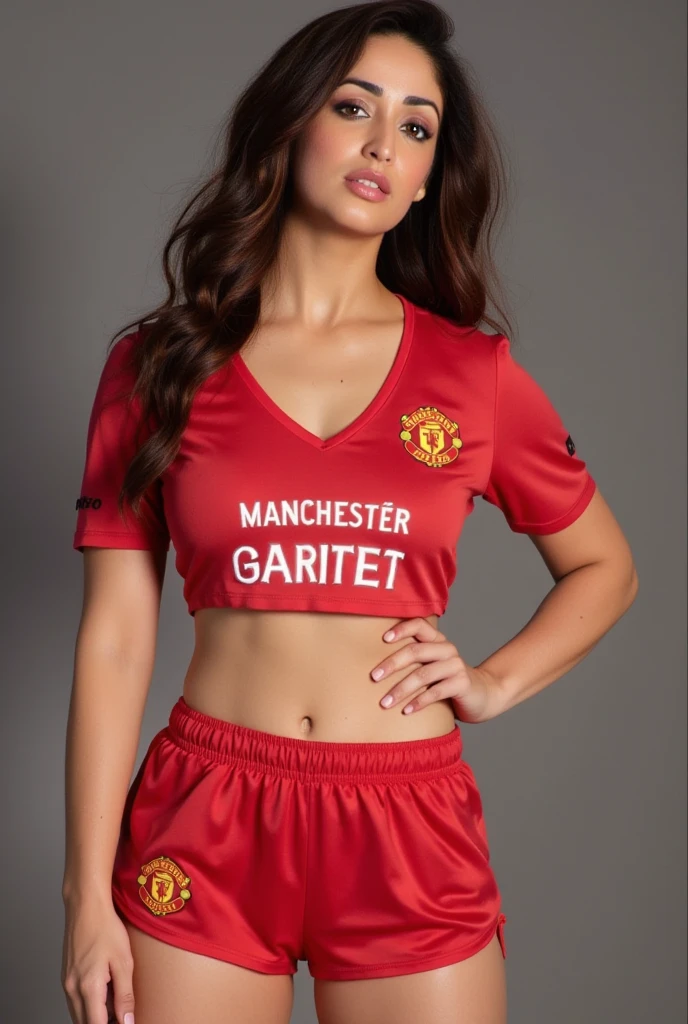 Victoria Beckham wearing Manchester United jersey with ripped shorts with a smile