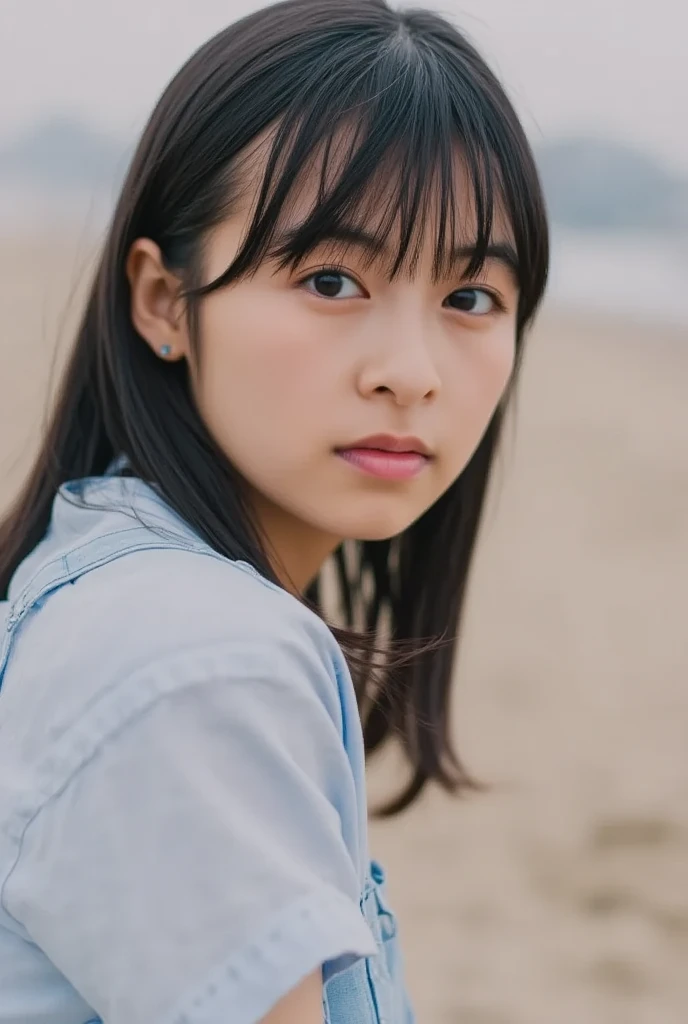 She is well-styled and has E-cup breasts, and she is standing in a blue