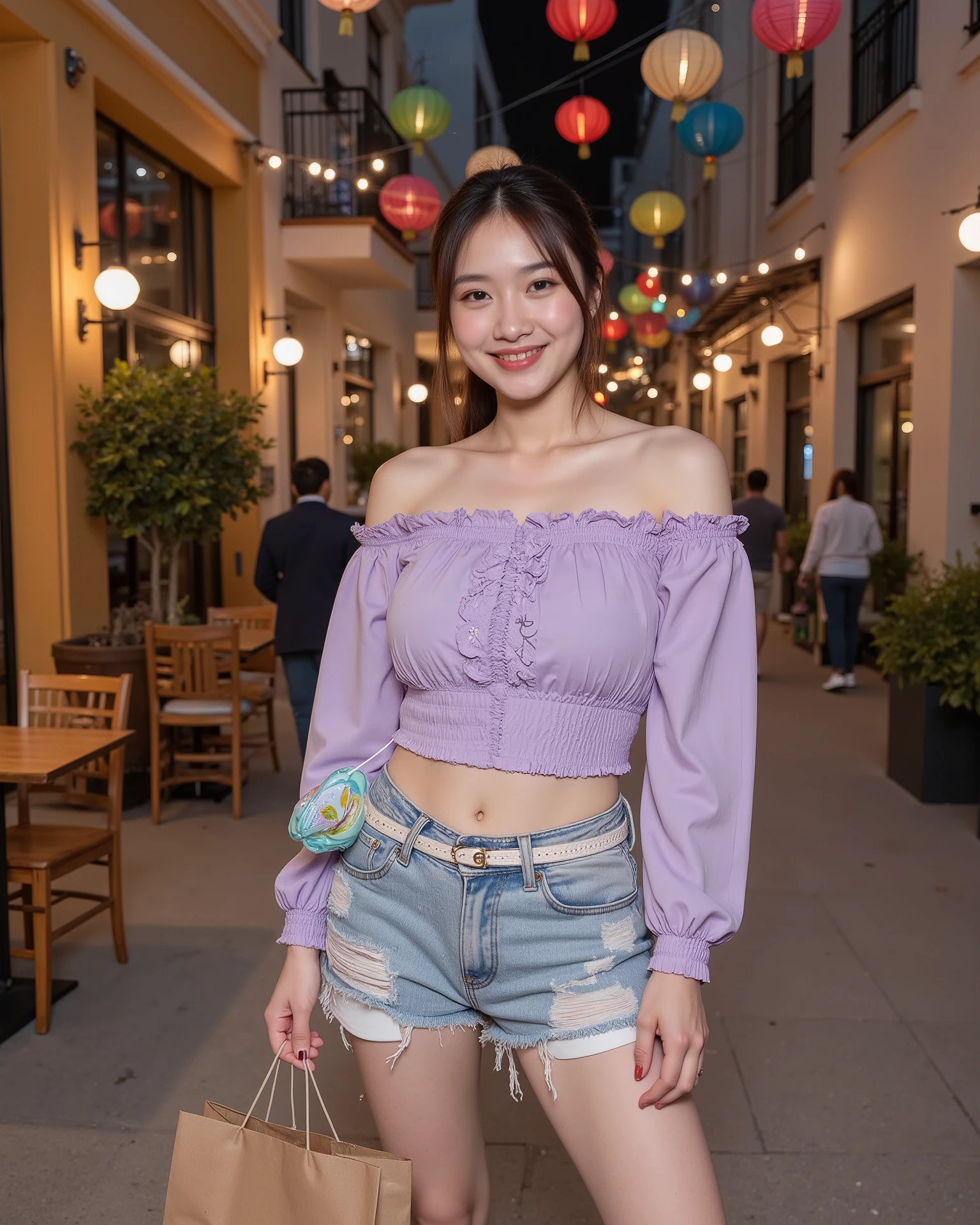 Full shot of a young woman standing on a paved street in a city at night.
The woman is light-skinned with shoulder-length, dark brown hair pulled back in a ponytail. She is smiling sexually and looking directly at the camera. She has large breasts. She is wearing a lavender-purple, off-the-shoulder, cropped top with long sleeves and a ruffled trim at the neckline. The top has a slightly textured or embroidered design. She is wearing light-wash, distressed denim shorts and a white belt. A small, clear, plastic purse with a light-blue flower design is on her hip.
A string of brightly colored paper lanterns are hung over the street. The buildings lining the street are a mustard yellow or beige color, and some have decorative elements. Wooden chairs are visible at a cafe-like setting. Several decorated paper lanterns of various colors decorate the street above.
The ground is paved with light-colored asphalt or concrete. The light suggests that it is late evening or night. People are visible in the background walking in the street that appear to be blurred and out of focus. A paper shopping bag is held in her left hand.