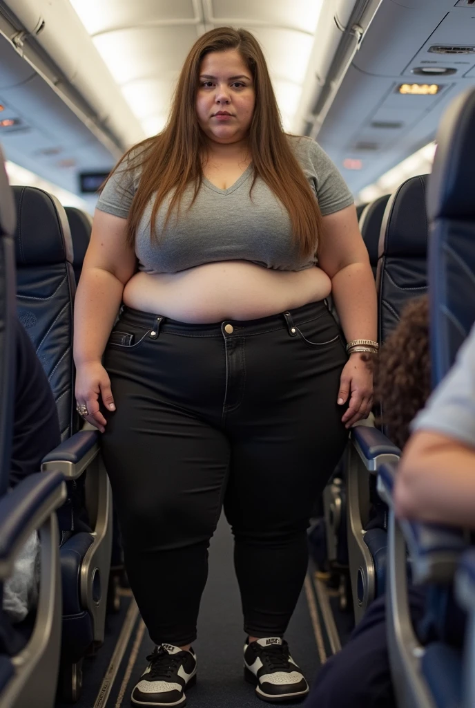 A plane passenger detailed photo of a Beautiful ginger SSBBW, with long wavy ginger hair, with big soft fat belly, thicc fat arms, thicc wide legs, big breast, in a cute green top tucked in her pants, and black pants, at airport waiting alone for the plane, with a suitcase next to her