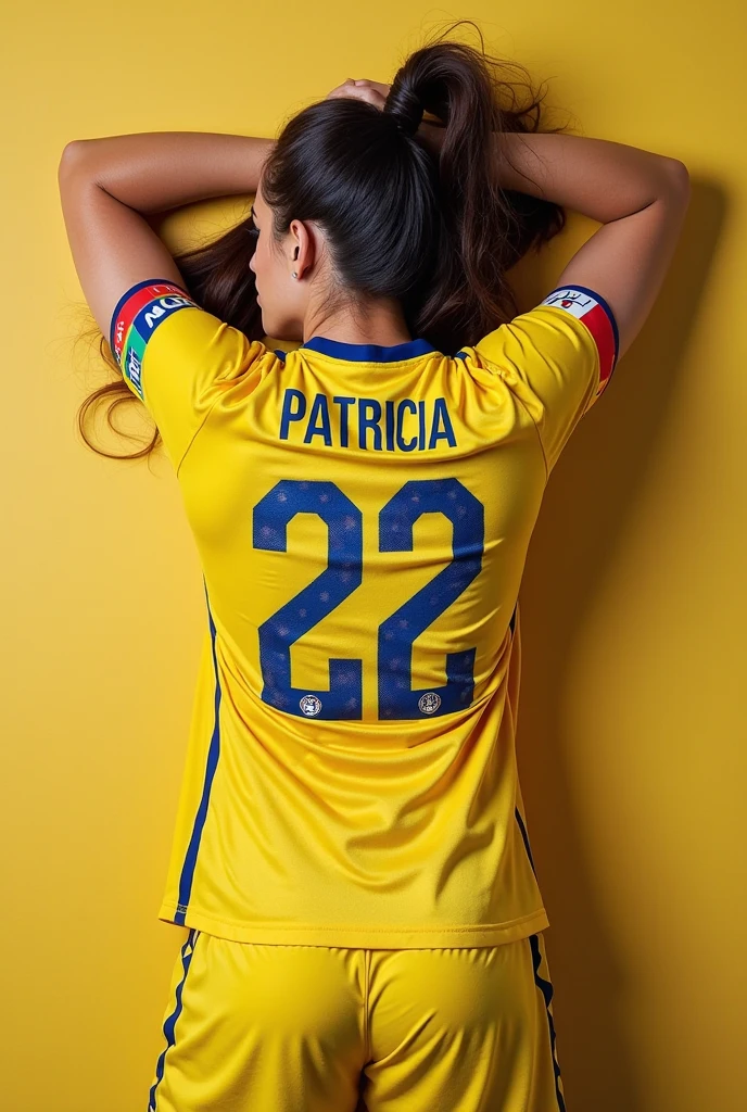 Woman with her back watching television with a soccer program wearing a Colombian national team shirt with text that says VIVIANA