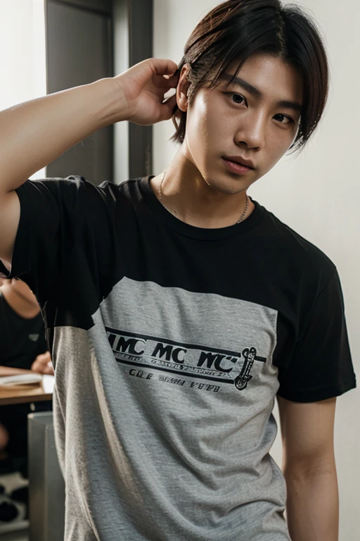 A 20 year old man wearing a hat with short hair wearing a distro t-shirt wearing a necklace in a simple coffee shop while holding a cigarette