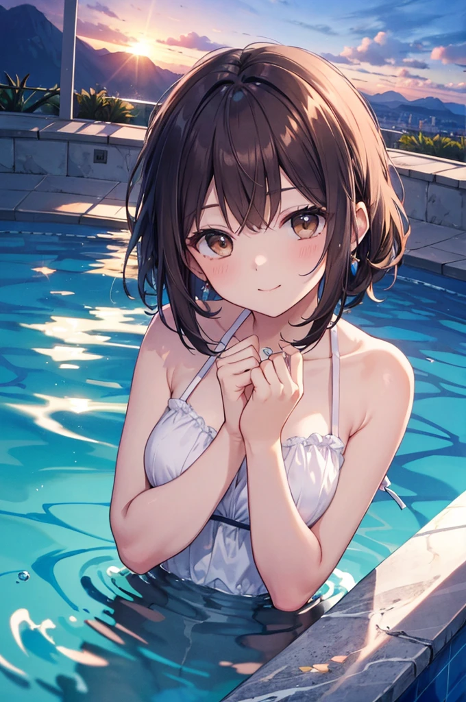 Cute girl with short brown hair swimming underwater in a swimming pool naked