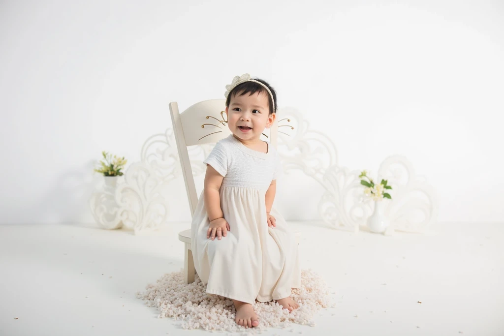 there is a baby girl holding a cake and a toothbrush, kewpie mayonnaise, photo taken with nikon d750, photo taken with nikon d 7 5 0, taken with canon eos 5 d mark iv, photo taken with sony a7r, taken with canon 8 0 d, she is smiling and excited, young asian girl, portrait image, child
