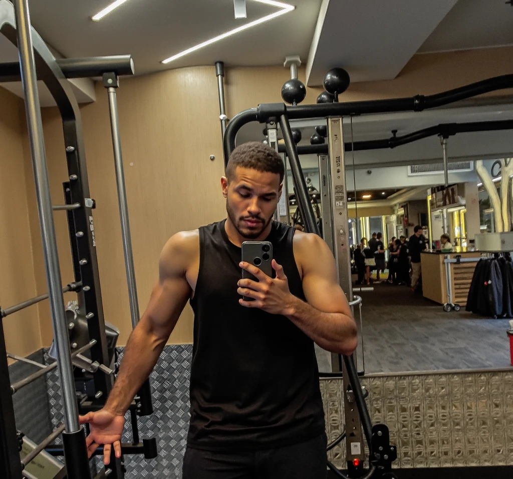 there is a man sitting on a bed with headphones on and a book, with head phones, with headphones, he has headphones, working out, listening to godly music, listening to music at 2 am, wearing headphones, listening to music, man is with black skin, wearing black headphones, looking at his phone, 2 3 years old, fit pic, shirtless