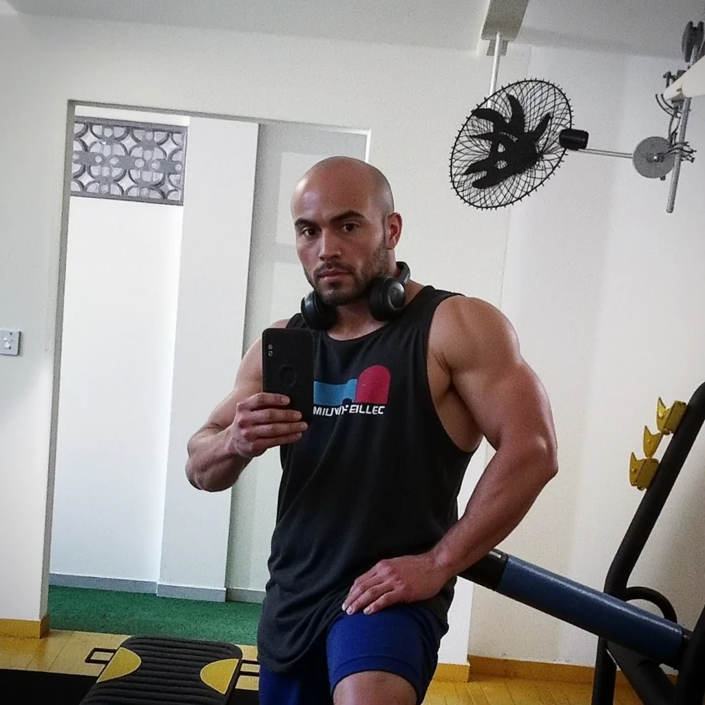a close-up of a man in a gym with a hat, Muito bonito. big muscles, extremamente musculoso, musculoso, André Rios, flexion, muito musculoso, muscular!!!, big muscles, vitor maristane, fisiculturista, absurdly muscular physique, flexion large muscles, ronaldo luis nazario de lima, big muscle, corpo fitness ifbb, musculine
