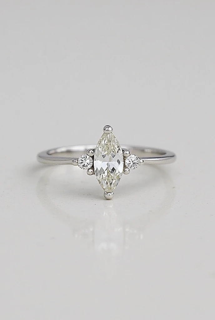 A delicate marquise cut ring with a pair of diamonds on the side