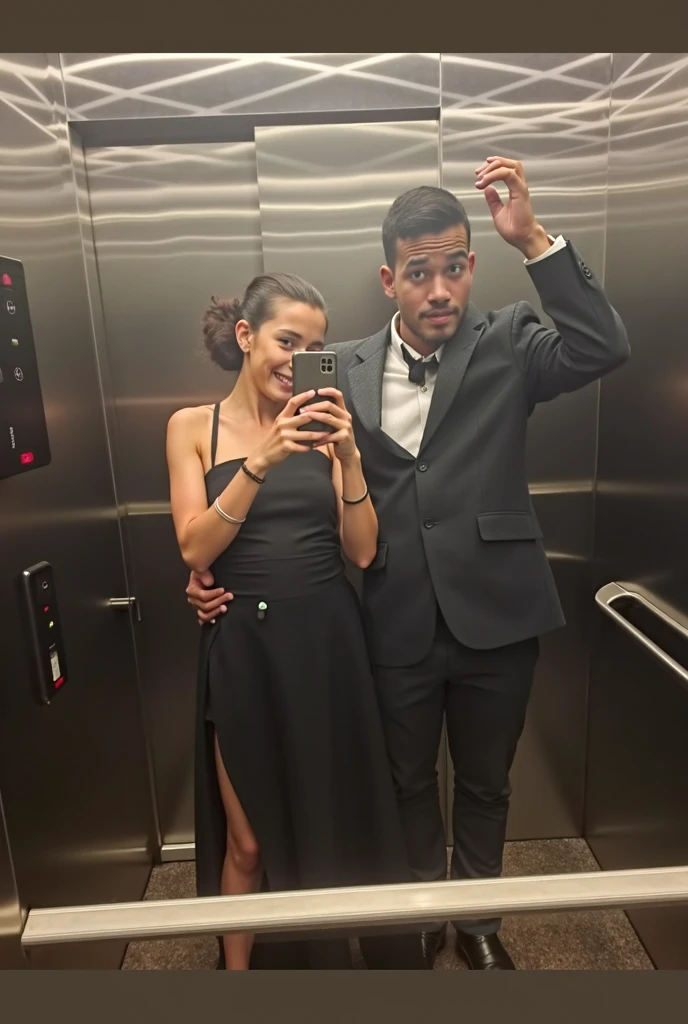 A man with a mustache and glasses taking a picture with a fair-skinned woman with dark brown hair tied up and black clothes in the elevator