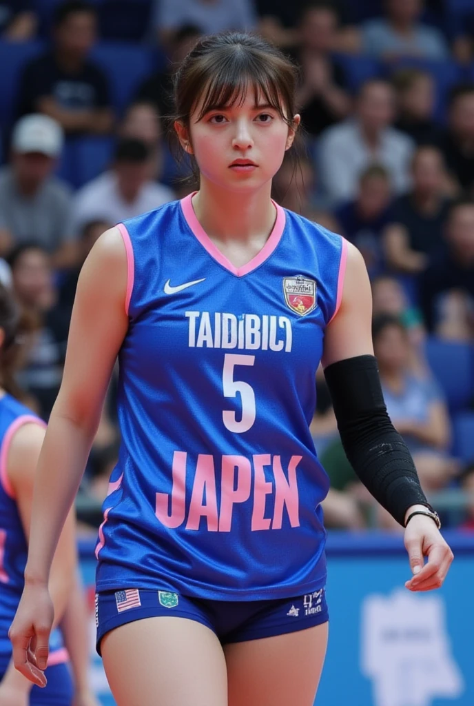 A professional volleyball player wearing a blue and pink jersey with the number "5" on it, labeled "AABBCC". She has a focused and slightly confident expression, with short brown hair styled simply. The jersey is detailed with " JAPEN " in large white and pink letters across the front. She is standing in a stadium or sports venue, with blurred audience members in the background, some wearing dark or casual clothing. while her arms is down by her side. She wears a black elbow brace on her right arm. The lighting is neutral, with a soft focus on the athlete, allowing her to stand out from the background. The background colors and the audience are mostly neutral, but some elements, such as the seats and the clothing, introduce pops of blue and pink, complementing the uniform. The camera angle is at eye-level, directly facing the athlete. The scene conveys a sense of readiness, focus, and slight encouragement or victory. upper volleyball uniform and bottom bikini uniform. back view and full body.