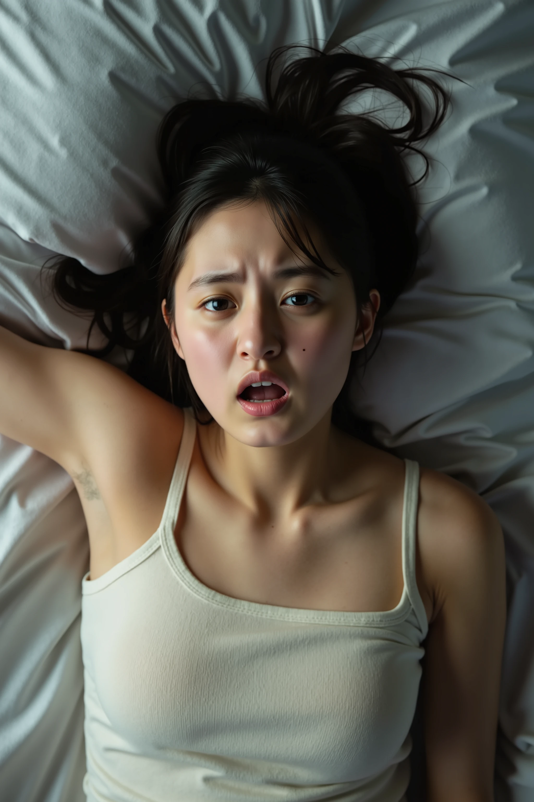 a high resolution photograph of a young Japanese woman lying in the bed with mouth open, innocent eyes, her head sticking out, bare shoulders, frowning, pain, scream, emotional face shot, face focus, from above, upside down, realistic facial expression, dramatic facial expression, detailed face, detailed eyes,
