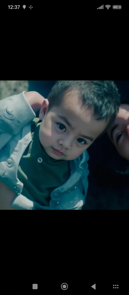 1 year old boy with black t-shirt and green pants