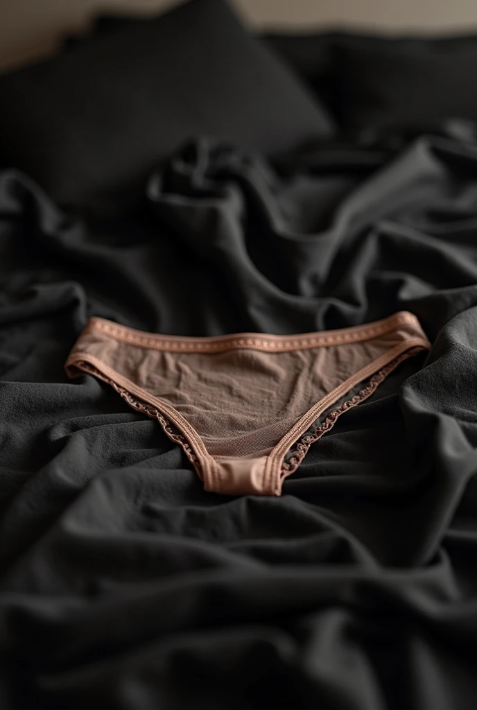 Close-up of black lace lingerie and the man touching it
with looks of desire, framed by soft lighting.