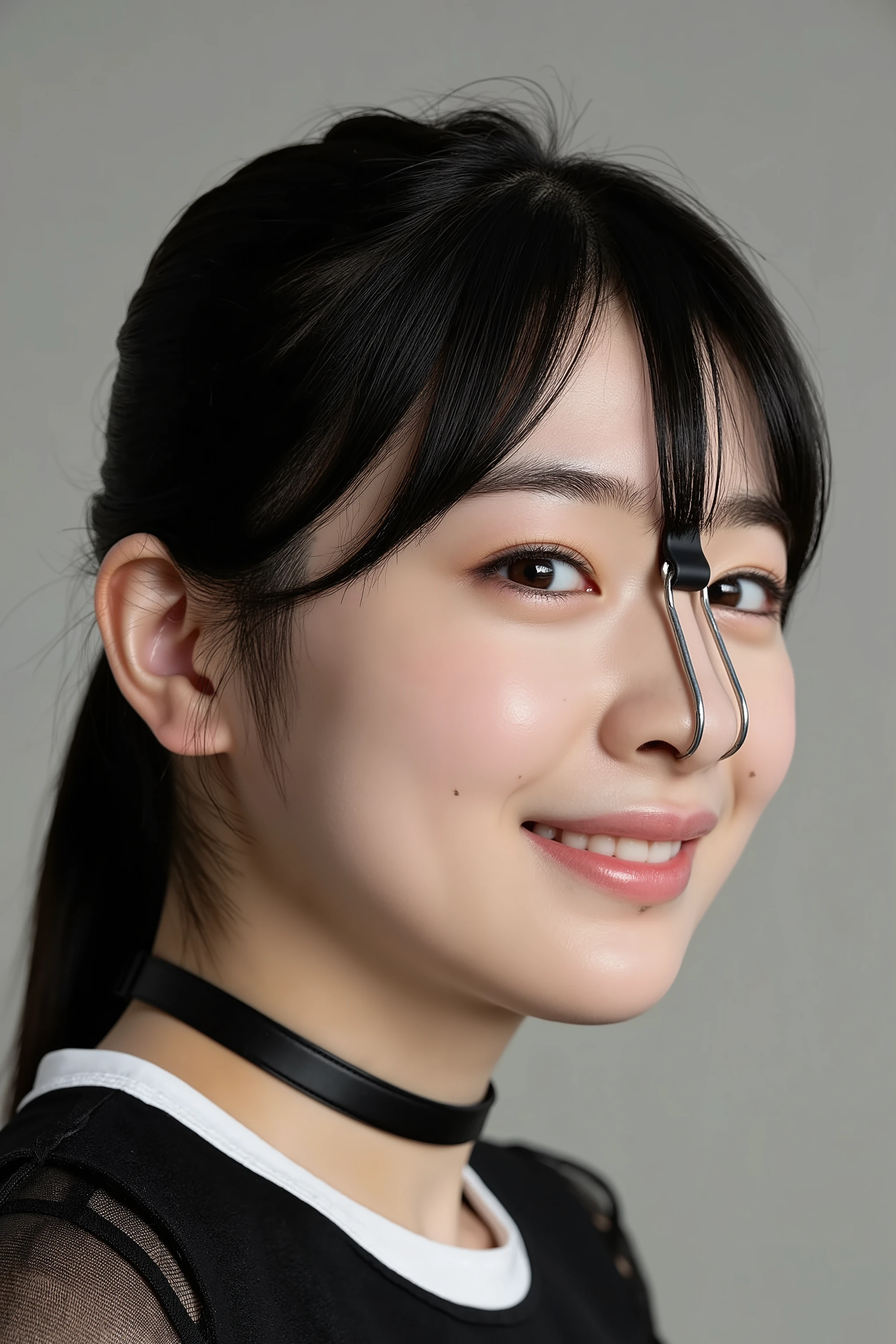 A high resolution photograph of a Japanese young woman, masterpiece, photo-realistic, natural lighting, film grain, portrait, fashion shoot, solo, 1girl, clothed, black hair, detailed face, detailed eyes, sophisticated nose, pale skin, fine-textured skin, (collar, nose hook with strap wrapped around top of her head, nose hook makes her nose look like a pig nose, showing nostrils:1.5), smile, looking at the camera, (profile, side view, view from below, facing up, chin-up, face focus:1.2), close-up of face, simple background,