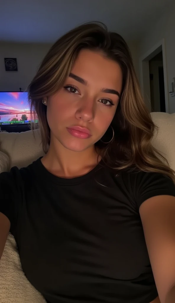 A hyperrealistic vertical flash selfie, taken with harsh direct flash that flattens facial features and casts soft shadows on the couch. The woman, Mikayla, is lounging on a sofa at night, with dim TV light in the room. She wears a loose black T-shirt that drapes naturally across her shoulder. Her long, slightly messy hair frames her face, catching soft light from the screen behind her. The flash creates crisp highlights on her skin, with subtle texture and natural tone variation. The background shows textured couch fabric, a crumpled blanket, and a faint, colorful TV glow. Floating dust particles, faint lens scratches, and subtle grain add photographic realism. Her facial expression is sleepy and unposed, enhancing the candid feel of a late-night iPhone snap.