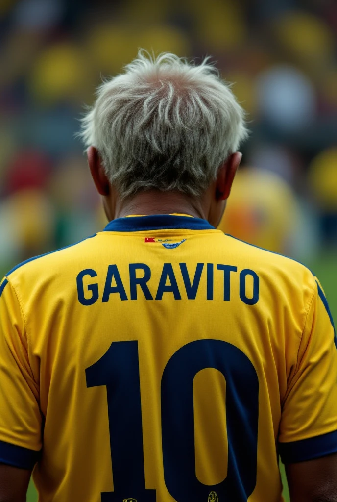 An old man who has a national team shirt and the name on the back says Toño Garavito and the number is 10 but who is from Colombia and is about 40 years old and looking towards Lante seeing the name Toño Garavito with the number 10
