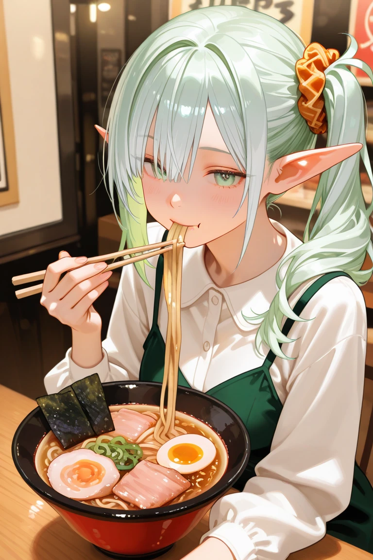 Cute anime girl in the real world. Her face is rounded. Her ears like an elf. Her eyes are large, light green and slightly slanted. Her hair style is side ponytail. The ponytail is braided. The front hair is cut diagonally above the eyes. Hair color is shiny silver. The side ponytail has an amber scrunchie attached. She wares a luxury dress. Location: A realistic ramen shop in the real world. She is eating ramen with chopsticks among other customers.