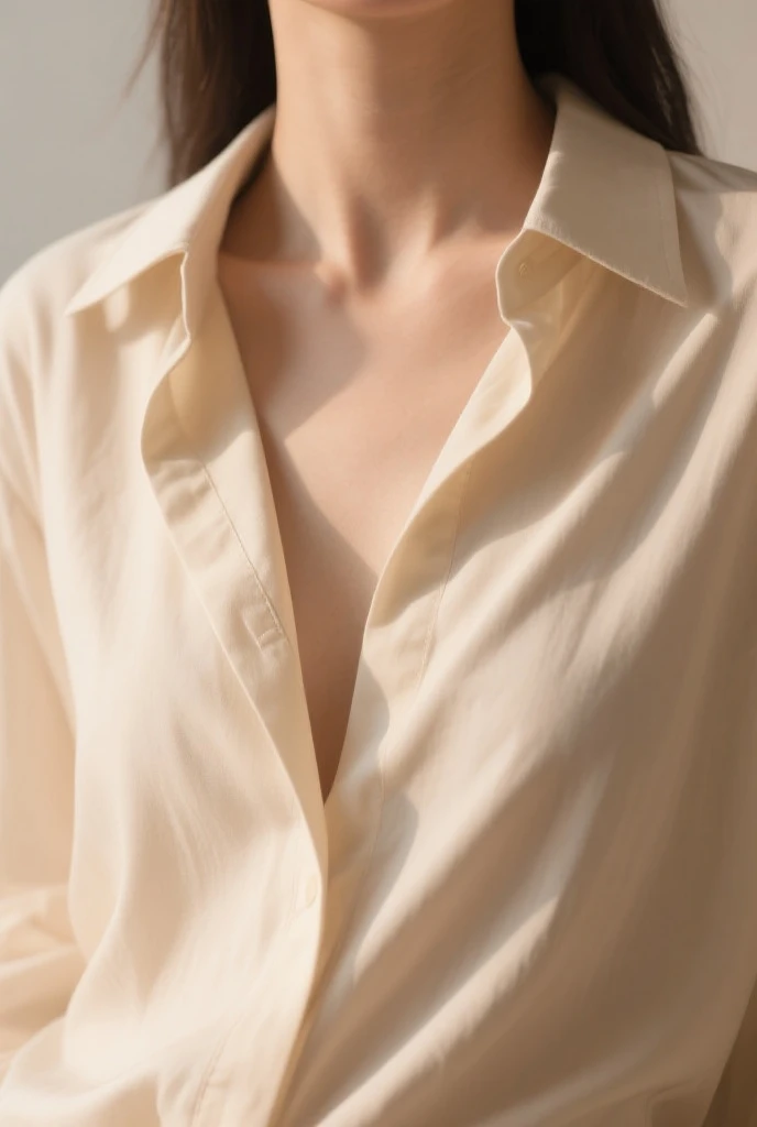 Close-up of the upper body of an elegant woman, highlighting sophisticated clothing. The woman is wearing a silk blouse with an impeccable cut that flatters her figure. The soft fabric shimmers under gentle light, while the details of the stitching and design showcase the quality and style of the garment. The image captures the beauty and luxury of the clothing, with a special focus on the details, conveying a sense of sophistication and elegance