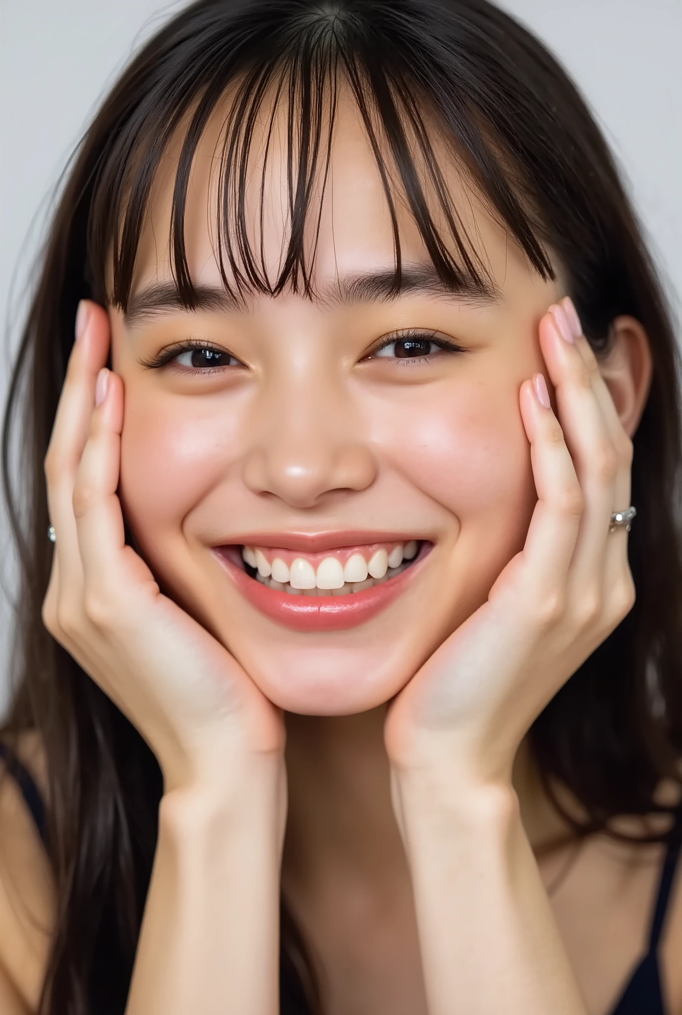 extreme close-up portrait, beautiful girl with her love-struck, radiant face filling the entire frame (95% face ratio), gently placing both open hands on her flushed cheeks with soft fingers, soft black camisole, white blurred background, eyes dreamy and half-lidded, deeply adoring gaze fixed straight at the viewer, irises ultra-detailed with intricate rainbow reflections and glowing catchlights, moist and sparkling eyes as if about to tear up from overwhelming joy, soft melting smile revealing slightly parted lips and upper teeth, skin with visible soft pores, realistic skin texture with warm lighting and subtle shadows, delicate eyelashes, glossy lips with natural highlights, cheeks glowing with deep blush, cinematic soft lighting, lifelike expression full of romantic euphoria, overflowing with happiness, warmth, and pure affection, subtly tilting her head as if whispering a name in total bliss, ultra photorealistic, masterpiece, 8K, hyperreal detail, skin pores, detailed iris texture, cinematic mood