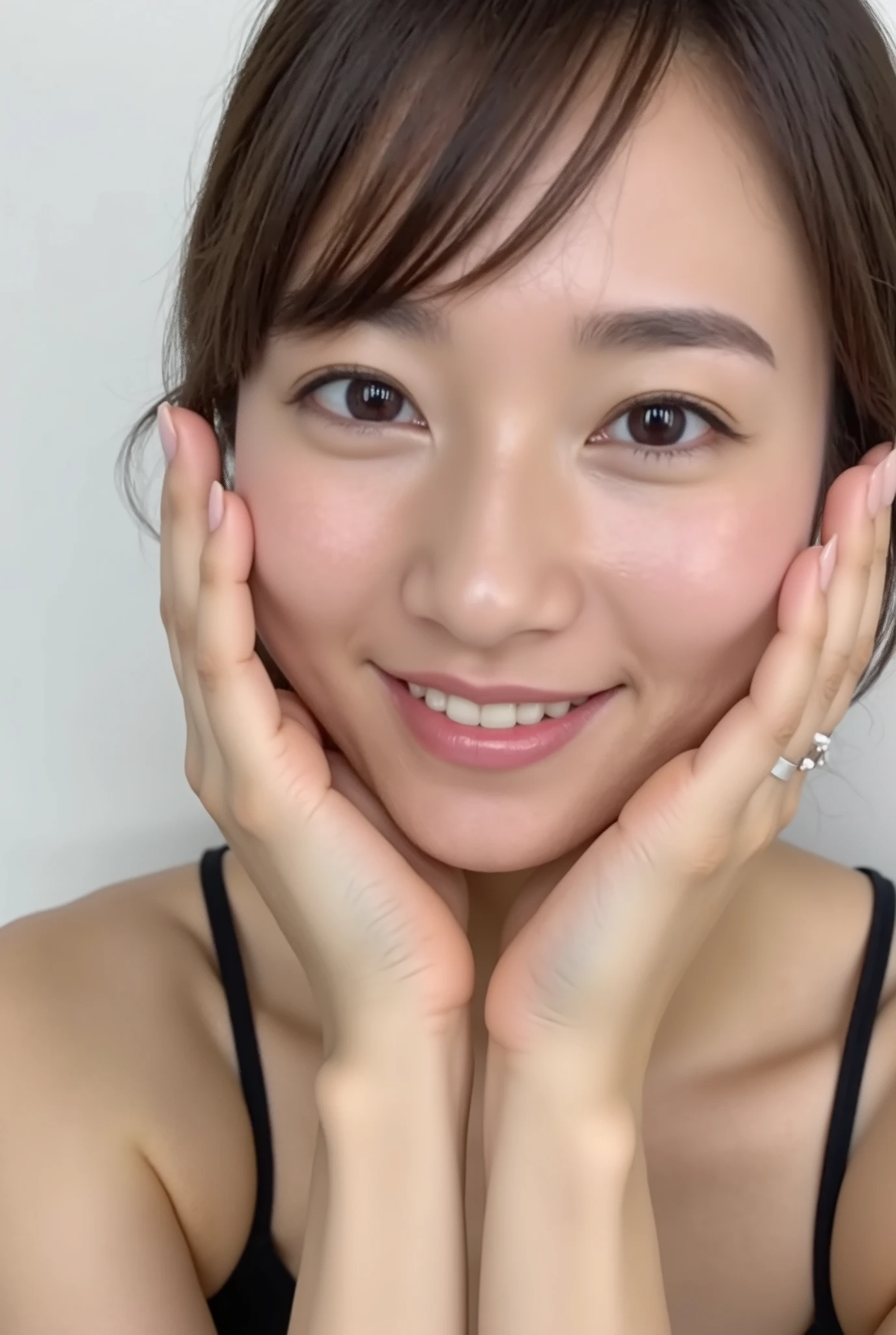 extreme close-up portrait, beautiful girl with her love-struck, radiant face filling the entire frame (95% face ratio), gently placing both open hands on her flushed cheeks with soft fingers, soft black camisole, white blurred background, eyes dreamy and half-lidded, deeply adoring gaze fixed straight at the viewer, irises ultra-detailed with intricate rainbow reflections and glowing catchlights, moist and sparkling eyes as if about to tear up from overwhelming joy, soft melting smile revealing slightly parted lips and upper teeth, skin with visible soft pores, realistic skin texture with warm lighting and subtle shadows, delicate eyelashes, glossy lips with natural highlights, cheeks glowing with deep blush, cinematic soft lighting, lifelike expression full of romantic euphoria, overflowing with happiness, warmth, and pure affection, subtly tilting her head as if whispering a name in total bliss, ultra photorealistic, masterpiece, 8K, hyperreal detail, skin pores, detailed iris texture, cinematic mood