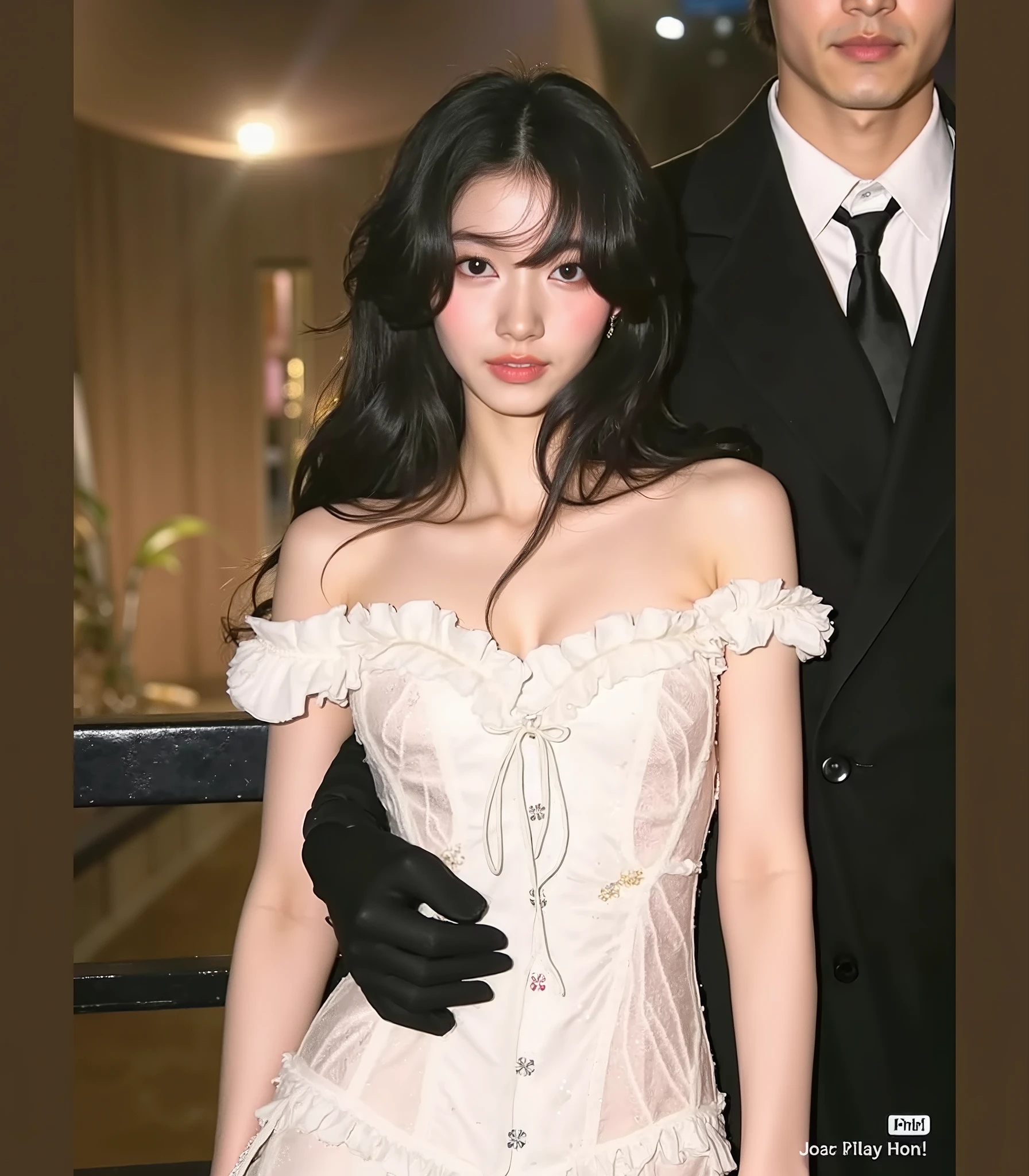 This is a high resolution photograph of a young Asian woman with fair complexion and straight hair, dark brown hair up to their shoulders. She has a slim figure and is wearing a strapless top, black velvet dress that has a high collar and a slightly flared skirt. The texture of the dress is soft and luxurious, with a subtle sheen . It is accessorized with a delicate gold bracelet on her left wrist and a simple gold necklace. His facial features are delicate, with a small , straight nose, full lips, and big, expressive eyes that are accentuated by subtle makeup, including a light pink blush and a soft pink lip color. She is posed with her right hand resting on her chin, her fingers gently touching her lips, and her left arm is relaxed by her side. The background is smooth, Light gray wall, overall muted which creates a stark contrast to her dark outfit. style. The lighting is soft and uniform, highlighting her features and the texture of her dress. the overall mood of the image is elegant and sophisticated, with a focus on the beauty of the subject and the simplicity of her outfit.