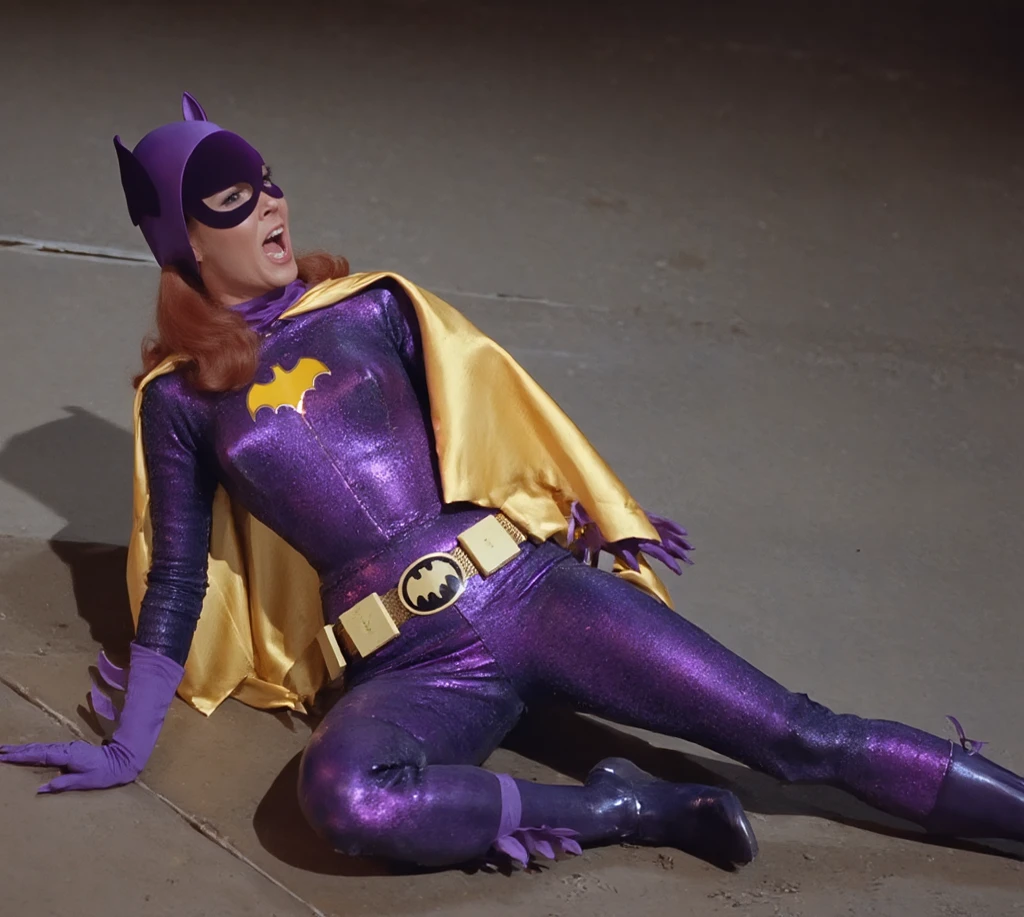 yvonne craig woman, with her purple outfit and yellow belt, she is desperate, her waist is squeezed by a red belt which contracts and squeeze her body, she cant move while her waist is squeezed by the red belt causing wrinkles on her purple outfit, she is in pain with her shoulders shrugged, screaming with her eyes wide open looking to camera, she is in pain, we see her injures, 60's style, analog film, medium shot (we dont see her feets), on grass, film grain