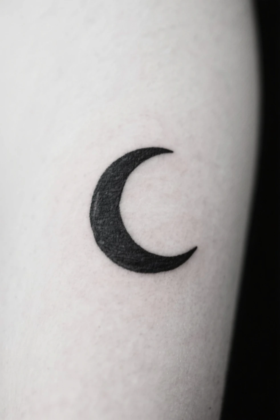 A little elbow tattoo, black, star shape, abstract, represented by the lyrics: "I am nothing but the sum of my regret Anchored to this hollow shell, numbness swallows me Flooding horizons in a blaze of frost and snow Lost in the folds inside the infinite dreamscape On the precipice of where worlds collide Remind me of the feeling lost in the distance Cleanse me of this soulless existence"