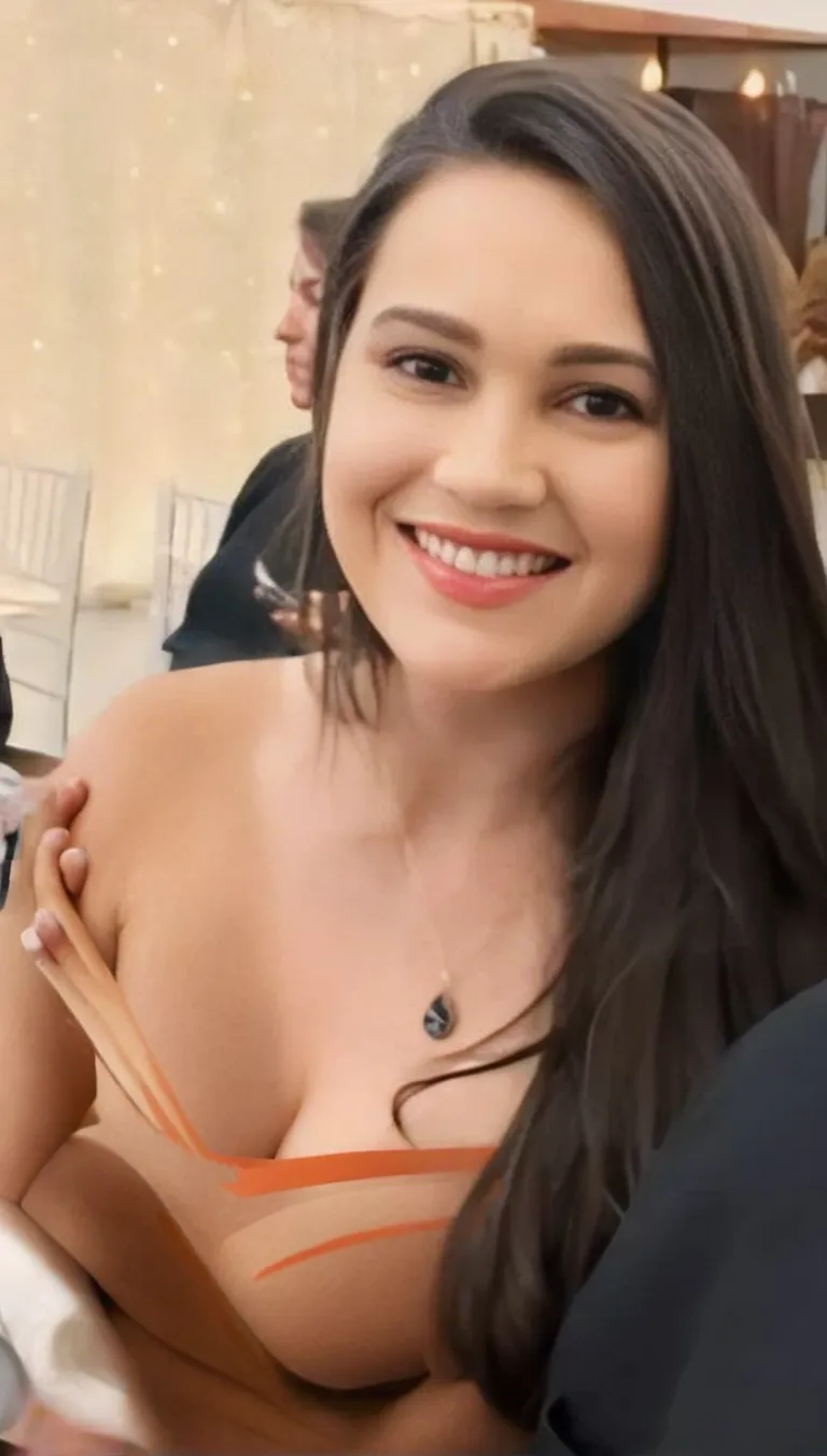 Long deep red lehnga, flower decoration in background, desirable Monika Bellucci, large breasts, 36DD cup size, perfect nipples with intricate details texture of skin. Red lips, smile, HDR lighting, 35MM f1.8 ISO100 , ultra realistic photo, sharp focus, 24mp,8k