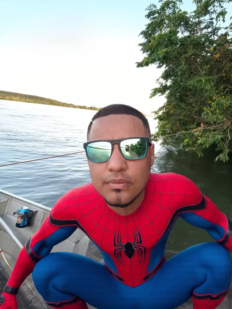 Tattooed man with Batman mask,with gold chain, Rolex, notebook, uniform written rollet he on top of a red Lamborghini, with a small gold roulette on top of the car, em uma praia
